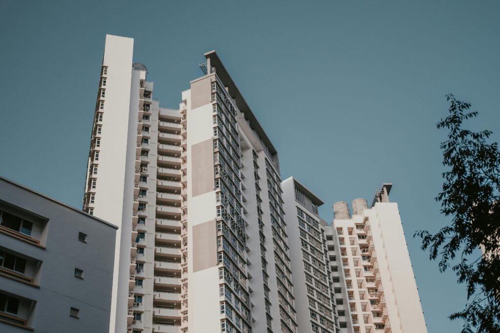 Low angle view of contemporary skyscrapers in a cityscape with a clear blue sky backdrop.